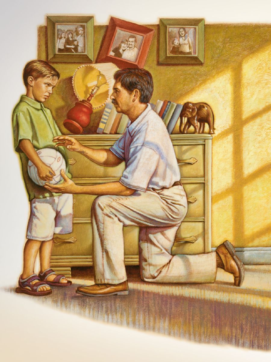 A boy talks to his father after he has kicked a ball in the house and knocked over a lamp