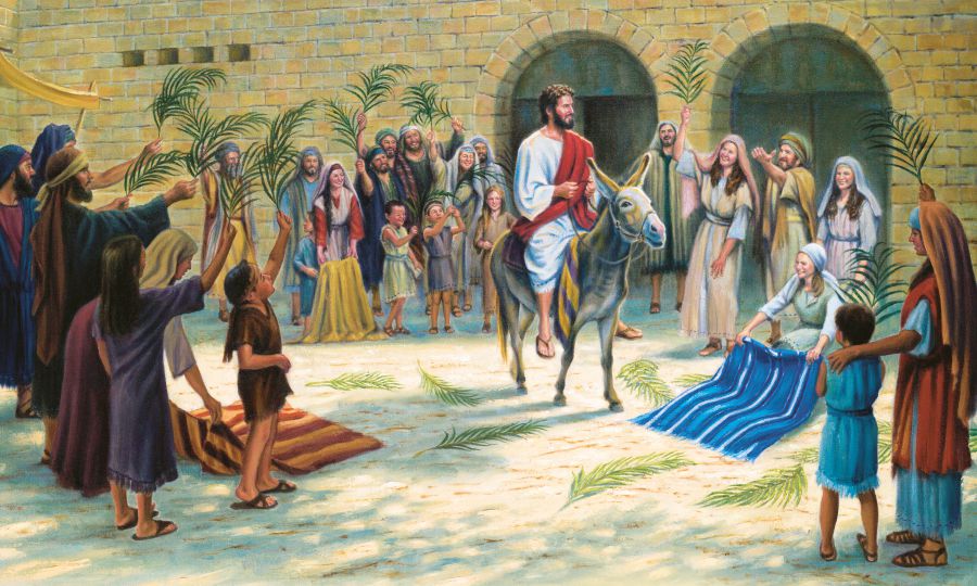 As Jesus rides into Jerusalem on a colt, people put their outer garments and branches on the road