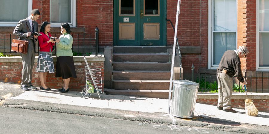 A couple preach to a woman on the street