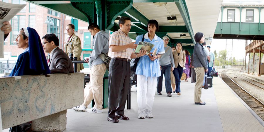 A brother witnesses to a woman at a train station