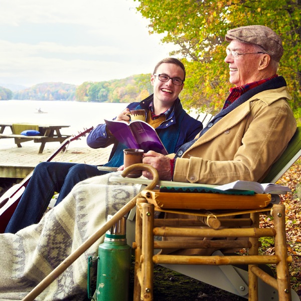 A young brother enjoys time at a lakeside with an elderly brother