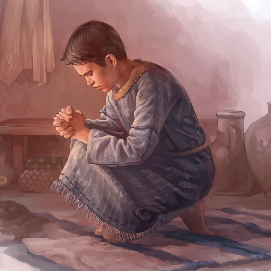 A boy kneels and prays