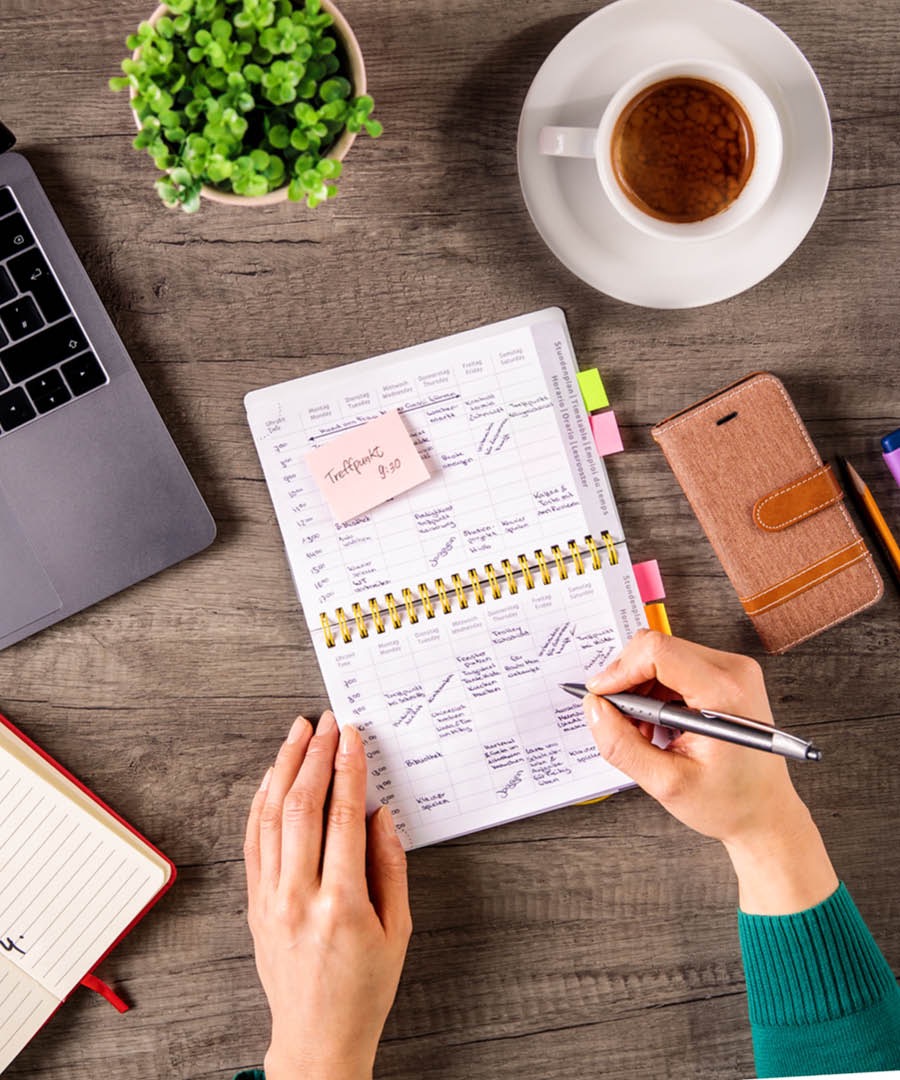 A woman uses a calendar to plan her routine