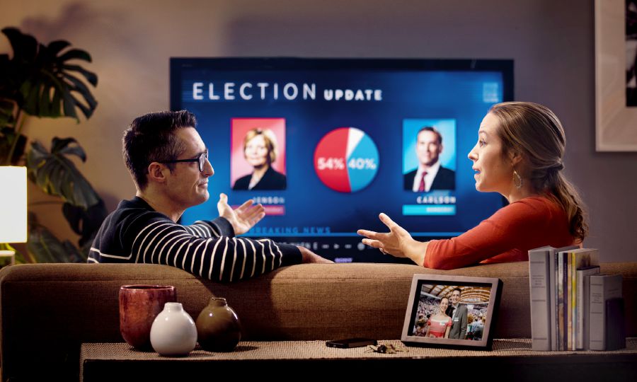 A Christian couple talking about a political election they are watching on television.