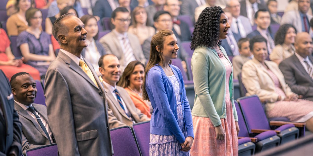 Baptism candidates stand, as their parents and Bible teacher proudly look on