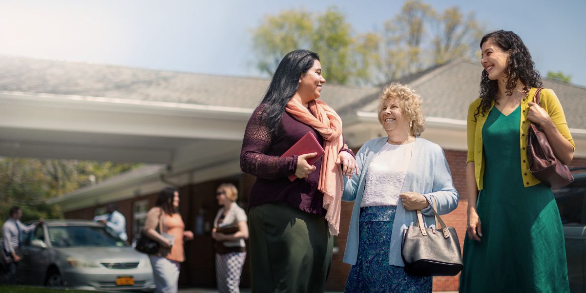 Diana greets sisters outside a Kingdom Hall