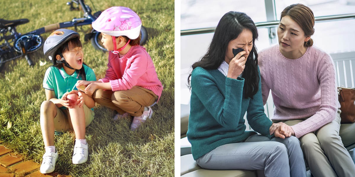 One girl comforts another girl who has skinned her knee; one woman comforts another woman who is crying