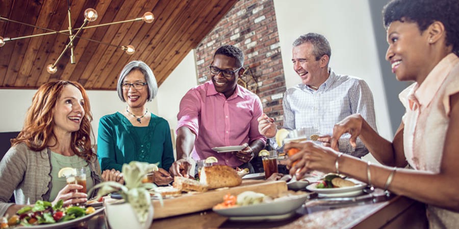 Friends of various races sharing a meal
