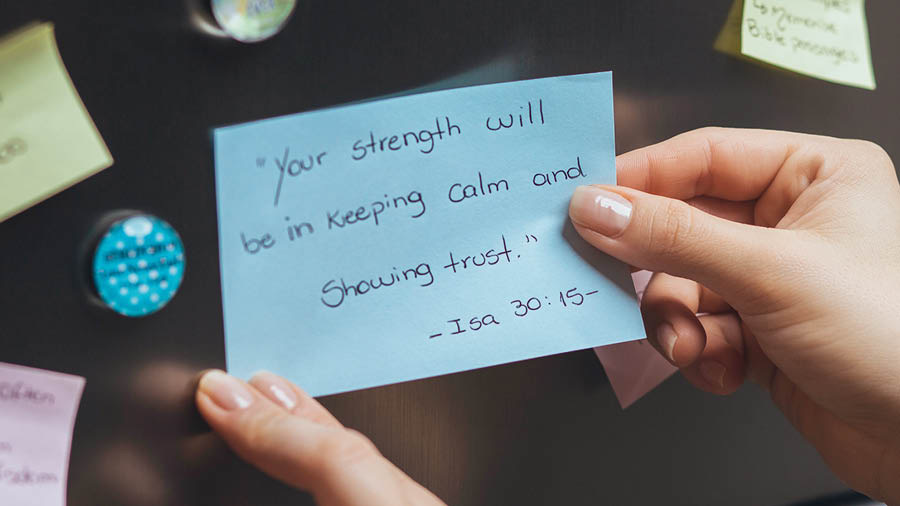The sister putting on her refrigerator a piece of paper on which she has written Isaiah 30:15.