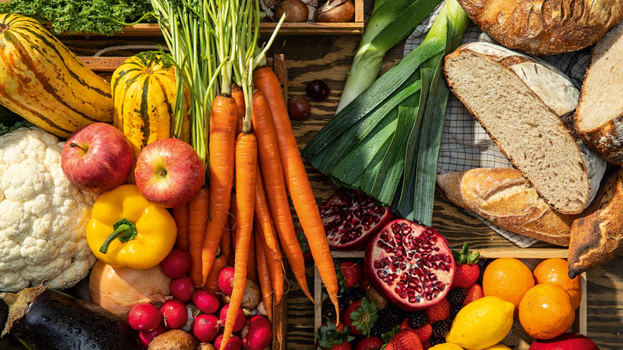 A variety of fruits, vegetables, and breads.