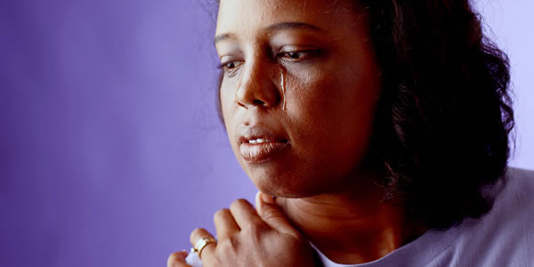 A sad woman shedding tears.