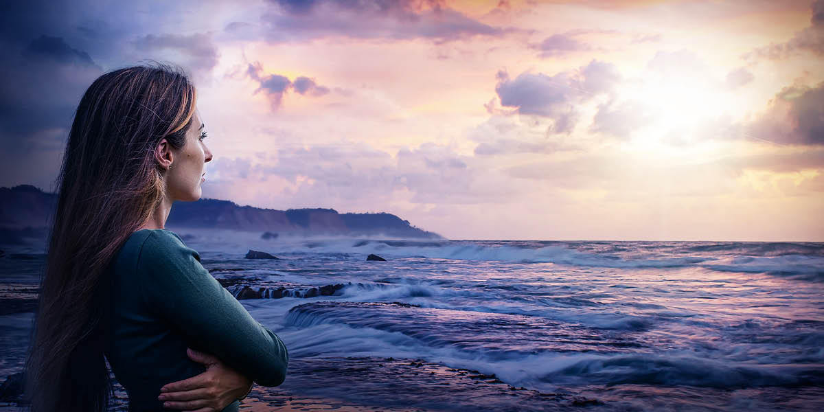 A woman looking hopefully toward the horizon.