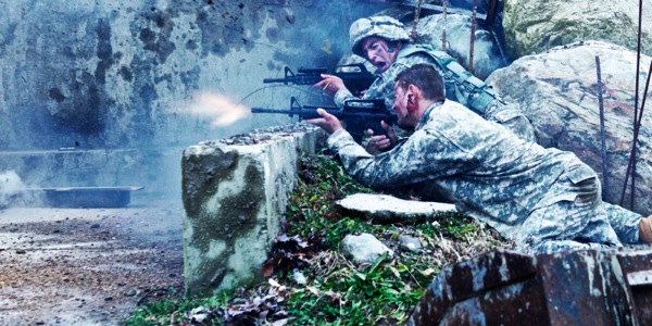 Camouflaged soldiers shooting guns in battle.