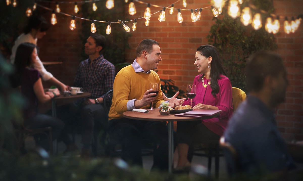 A husband and wife have dinner at a restaurant