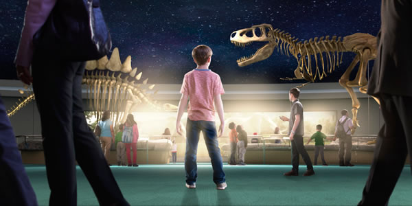 Students in a museum looking at dinosaur fossils
