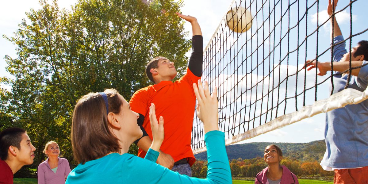 A group of young people playing volleyball