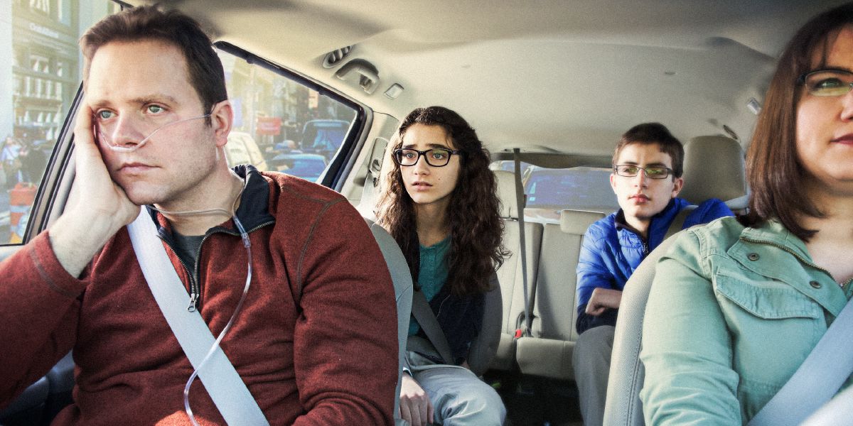 A teenage boy and girl observe their sick father