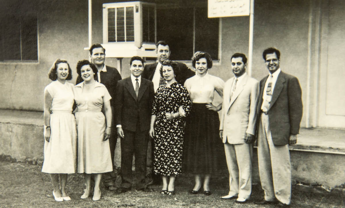 Milto and Doris with friends standing in front of a missionary home.