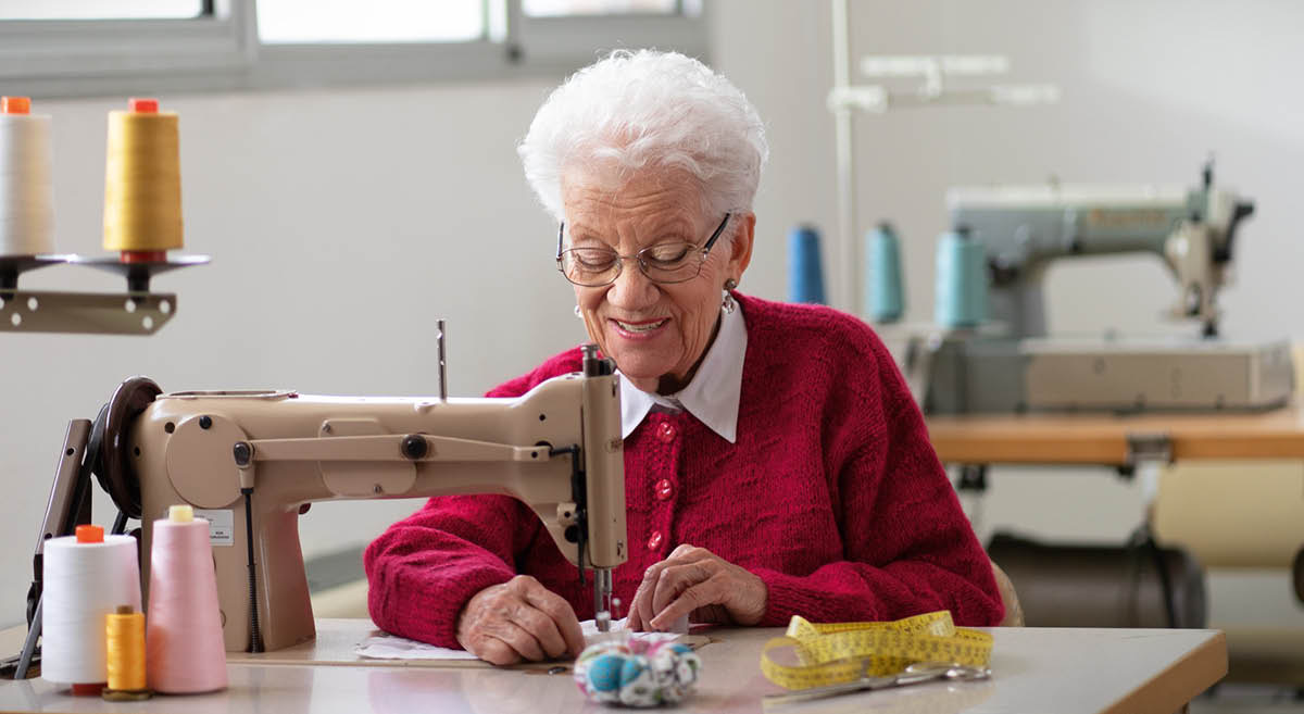 Dorina using a sewing machine at Bethel.