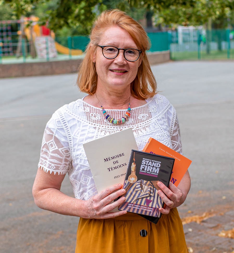 Maud holding three publications.