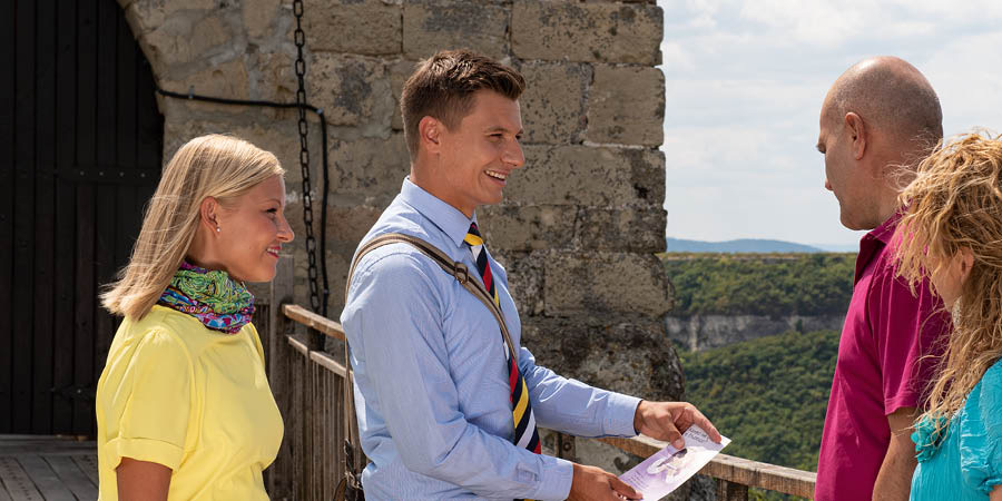 Nadja and Petteri offering a tract to a man and a woman.