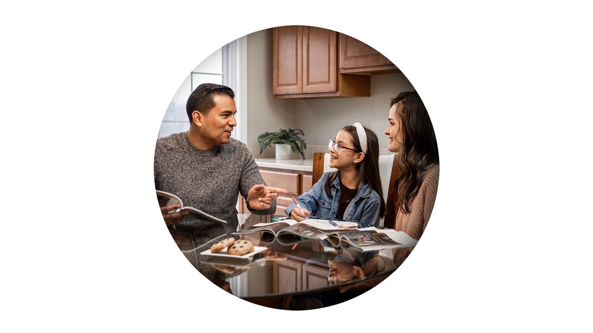 The brother conducting family worship with his wife and daughter.