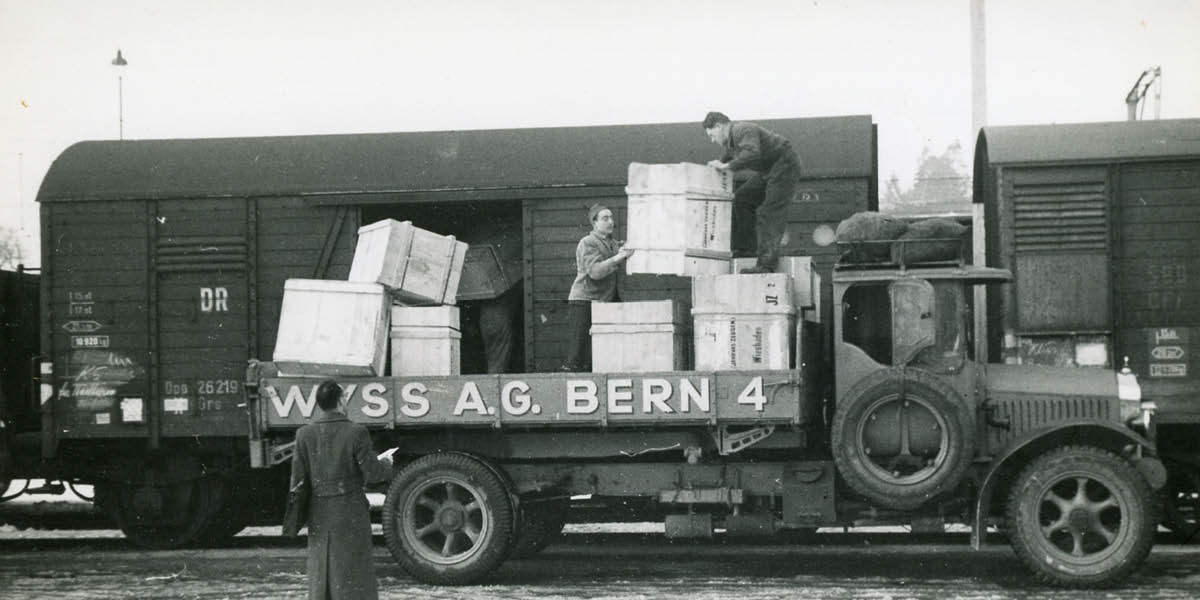 Jehovah’s Witnesses loading crates of donated items onto a railway car bound for Germany.
