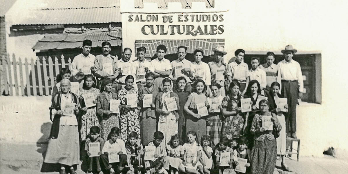 A group of Jehovah’s Witnesses holding copies of “The Watchtower” in Spanish while standing in front of their meeting place in 1952. The sign on the building reads in Spanish: “Hall for Cultural Studies.”