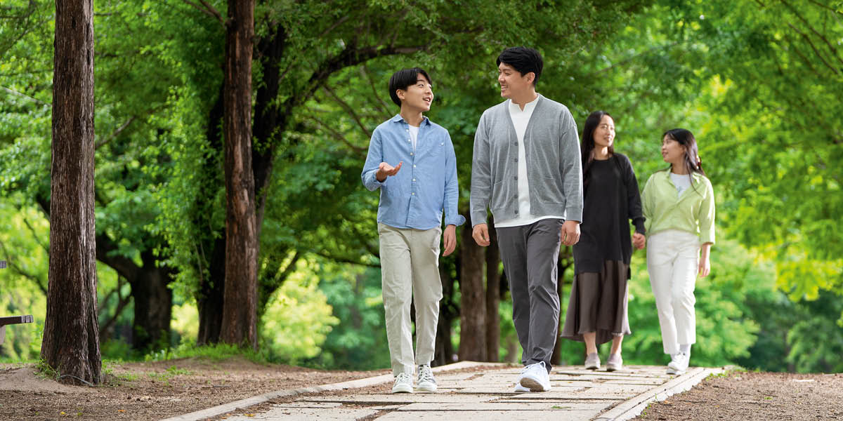 Happy children enjoy talking to their parents while walking in a park