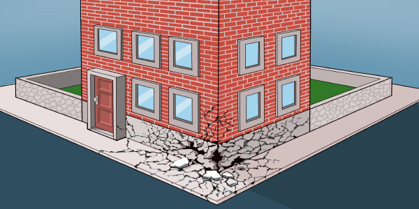 A brick building with a cracked foundation