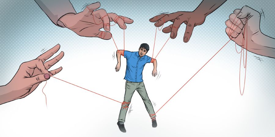 A young man has strings attached to him, as if being controlled like a puppet