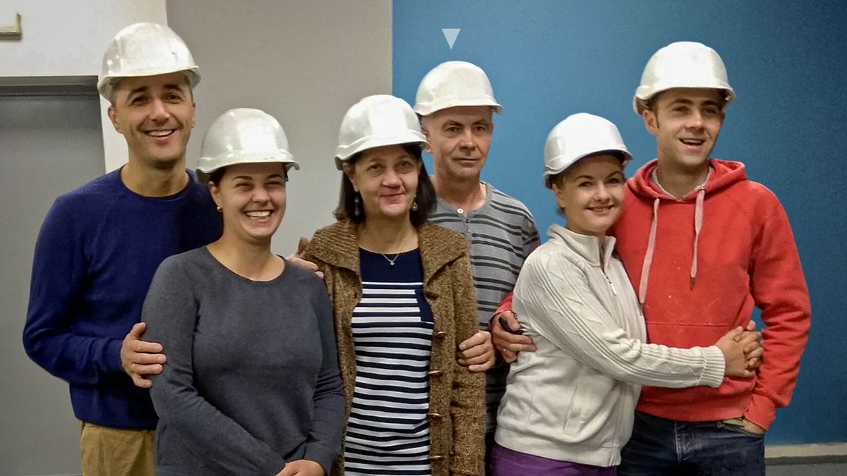 Oleh and his family wearing hard hats while at a Kingdom Hall construction project.