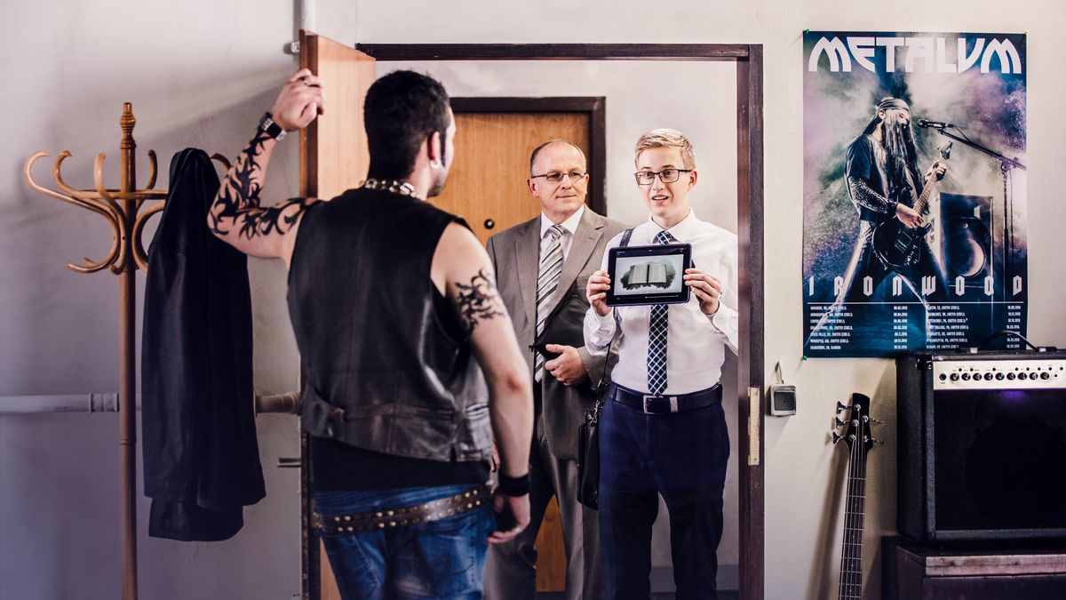 Two brothers in the ministry, preaching to an intimidating man with tattoos. The younger brother plays the video “Why Study the Bible?” A poster of a heavy metal band hangs on the man’s wall.